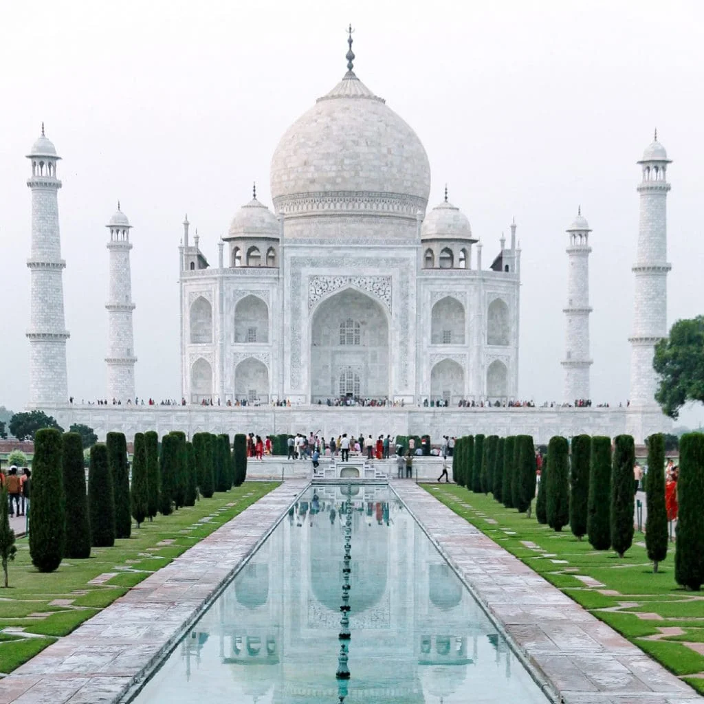 Hình ảnh đẹp Taj Mahal màu trắng phản chiếu trên hồ nước giữa khu vườn xanh mát
